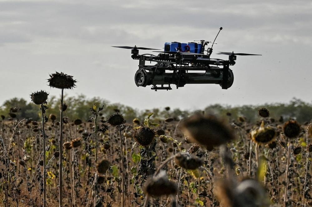 An FPV drone with an attached portable grenade launcher is seen during a test flight conducted by Ukrainian servicemen at their position near a frontline.