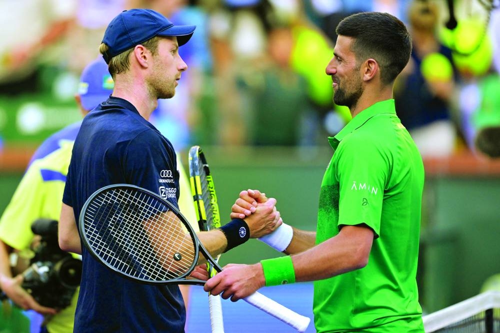 
Botic Van De Zandschulp of the Netherlands shakes hands with Novak Djokovic of Serbia after winning his second round match of the BNP Paribas Open at the Indian Well Tennis Garden. 