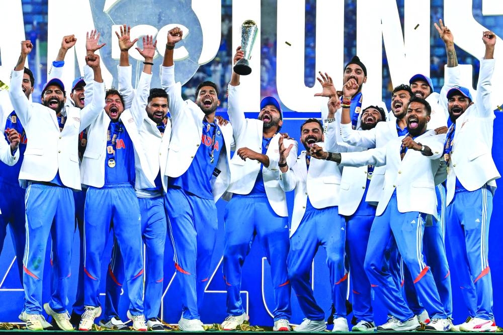 
India’s players celebrate with the trophy after winning the ICC Champions Trophy final against New Zealand at the Dubai International Stadium in Dubai yesterday. (AFP) 