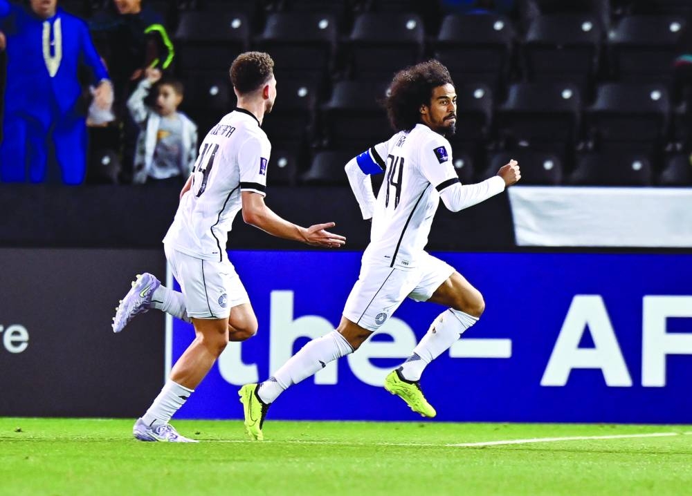 Al Sadd’s Akram Afif (right) celebrates after scoring against Al Wasl in the last 16 second leg clash of the AFC Champions League Elite at the Jassim Bin Hamad Stadium in Doha yesterday. PICTURES: Noushad Thekkayil