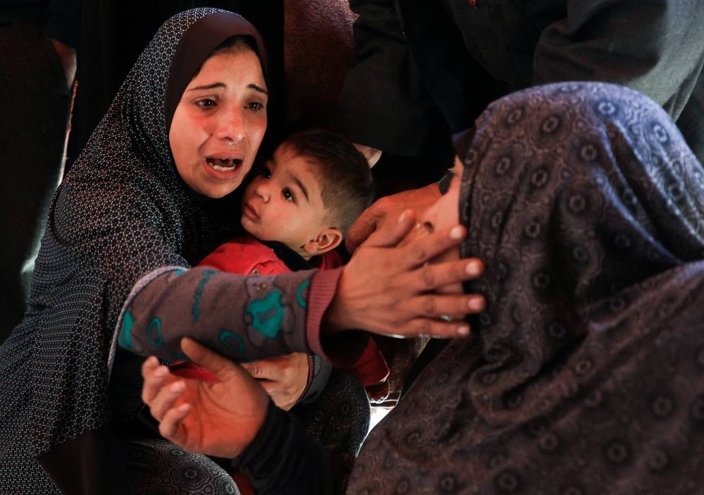 Mourners react during the funeral of Palestinians killed in an Israeli strike, in Gaza City, on Tuesday. REUTERS