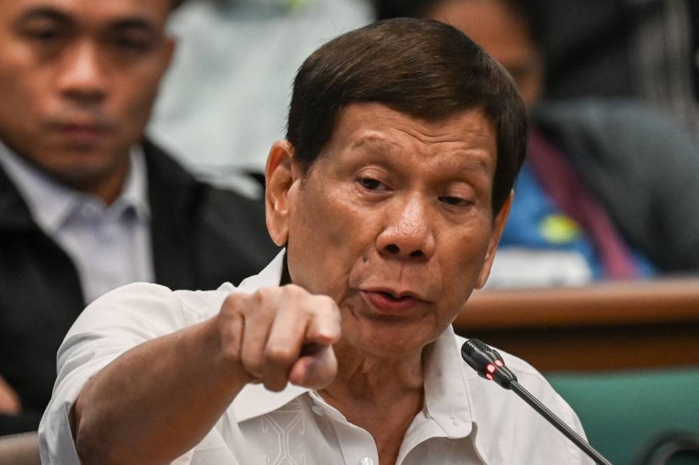 Former Philippine president Rodrigo Duterte gestures as he attends a senate probe on the drug war during his administration, in Manila on October 28, 2024. AFP