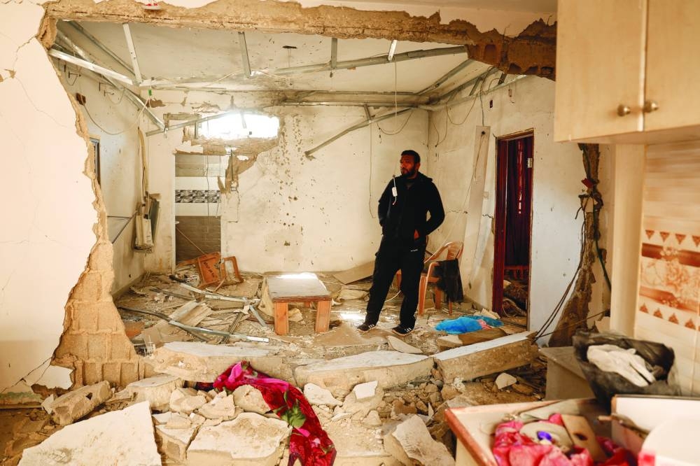 
A man stands in a damaged building, near the site where a number of Palestinians were killed in an Israeli raid, in Jenin, in the occupied West Bank, yesterday. 