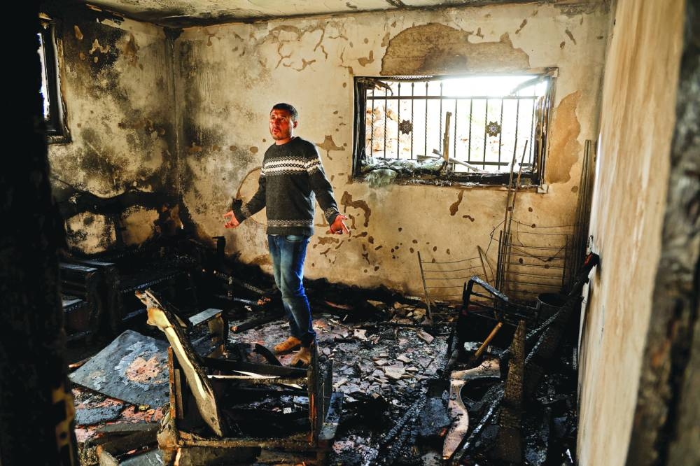 A Palestinian man inspects damage in a burnt room following an Israeli settlers' attack, near Duma in Nablus, in the occupied West Bank, yesterday.
