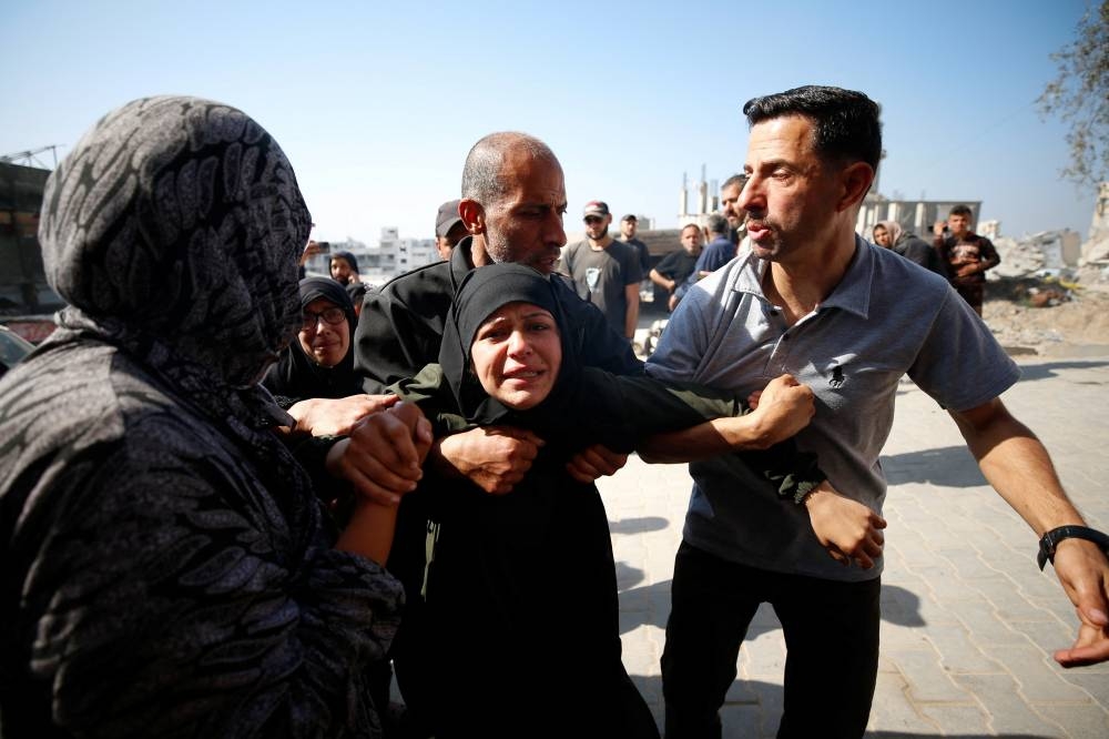 Mourners react near the bodies of Palestinians killed in an Israeli strike, in the northern Gaza Strip on Saturday. REUTERS