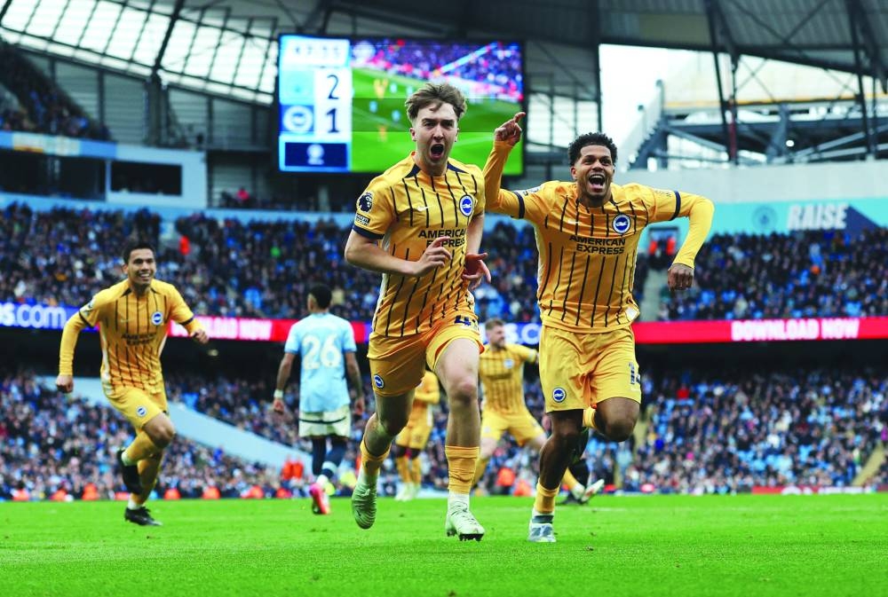 
Brighton’s Jack Hinshelwood and Georginio Rutter celebrate after Manchester City’s Abdukodir Khusanov scored an own goal during the Premier League match in Manchester. (Reuters) 