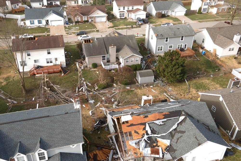 Debris lies around damaged houses the morning after a tornado touched down in Florissant, Missouri, on Saturday in a drone view. REUTERS/