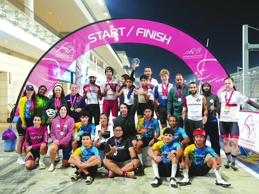 
Winners and participants pose for a picture at the end of the ITT Cycling Race at Lusail International Circuit. 