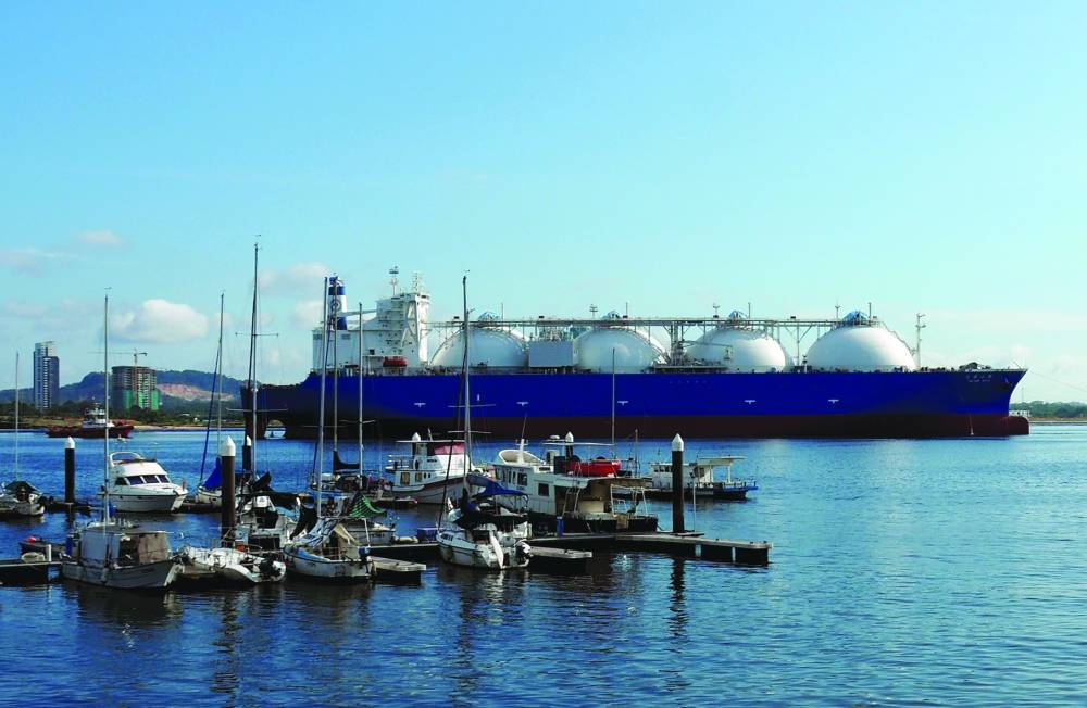 An LNG tanker passes boats along the coast of Singapore. LNG exports are projected to expand significantly over the next three decades, the HECF has said in its ‘Global Gas Outlook 2050’.