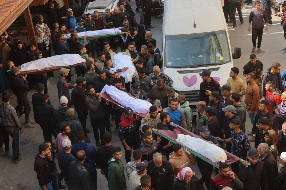 The bodies of victims killed in overnight Israeli airstrikes on the Gaza Strip are carried on stretchers at Al-Ahli Arab hospital, also known as the Baptist hospital, in Gaza City ahead of their burial, on Tuesday. AFP