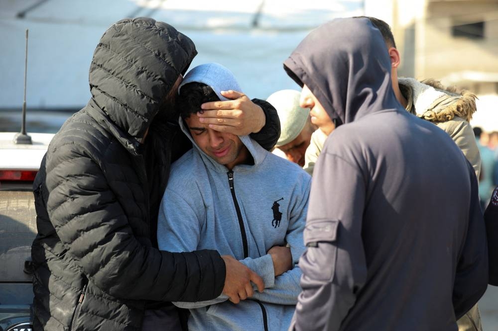 People mourn Palestinians killed in Israeli strikes, at Al-Aqsa Martyrs hospital, in Deir Al-Balah in the central Gaza Strip, on Tuesday. REUTERS