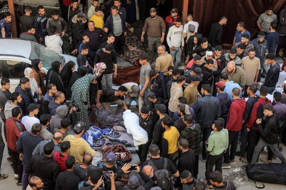 People gather in the yard of the Ahli Arab hospital, also known as the Baptist hospital, to mourn and bid farewell to the bodies of victims killed in Israeli bombardment, in Gaza City on Tuesday. AFP