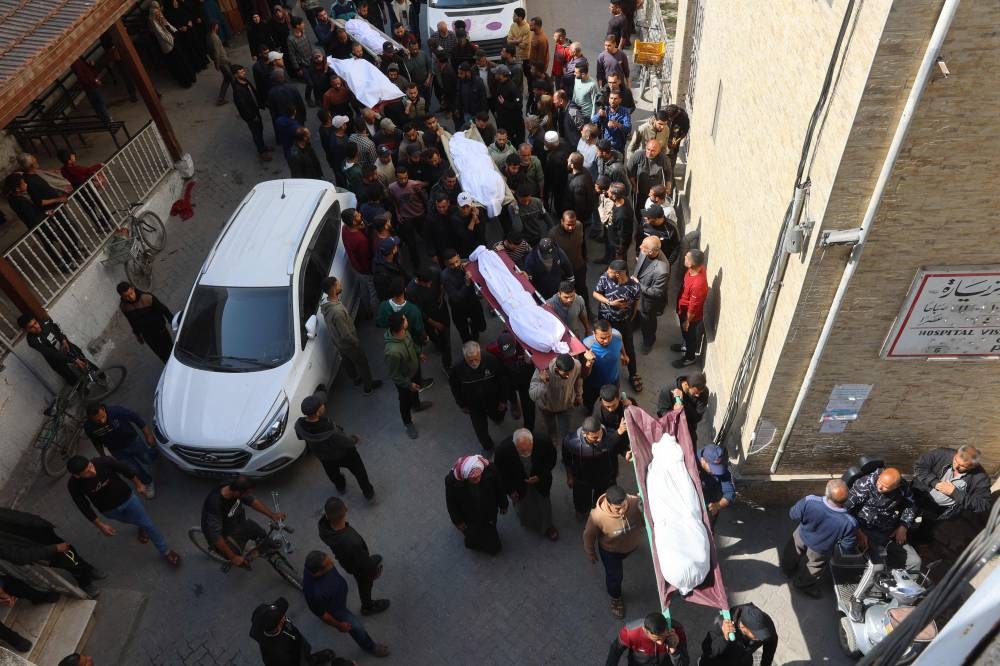 The bodies of victims killed in overnight Israeli airstrikes on the Gaza Strip are carried on stretchers at Al-Ahli Arab hospital, also known as the Baptist hospital, in Gaza City ahead of their burial, on Tuesday. AFP