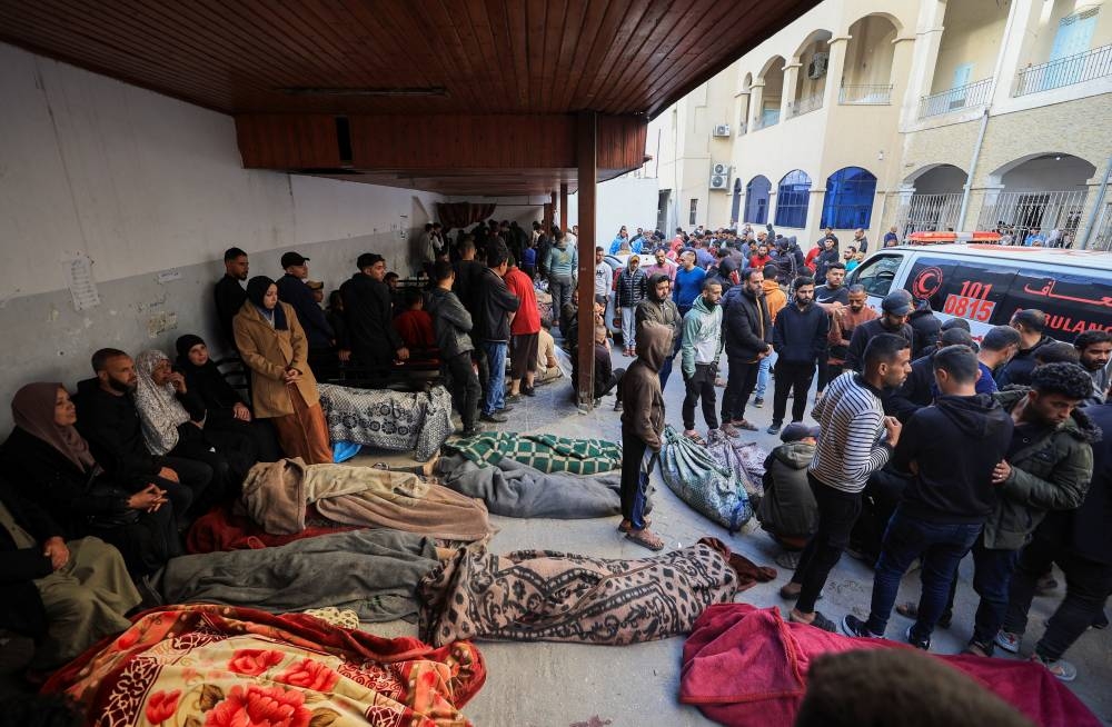 Mourners gather near the bodies of Palestinians killed in Israeli strikes, at a hospital in Gaza City, on Tuesday. REUTERS