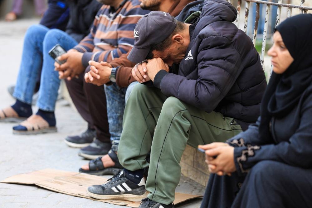A mourner reacts as people gather near the bodies of Palestinians killed in Israeli strikes, at a hospital in Gaza City, on Tuesday. REUTERS