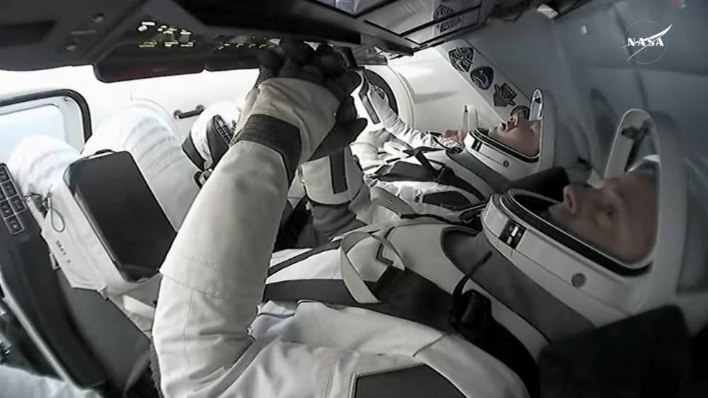 Astronauts Butch Wilmore and Sunita Williams return to earth from the International Space Station in a Crew Dragon capsule before their planned splash down off the coast of Florida, on Tuesday in a still image from video.  NASA TV/Handout via REUTERS