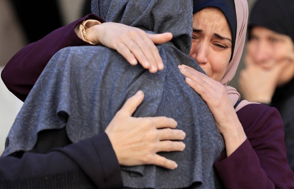 Mourners react next to the bodies of Palestinians killed in Israeli strikes, at Al-Ahli Arab Baptist hospital, in Gaza City, on Wednesday. REUTERS