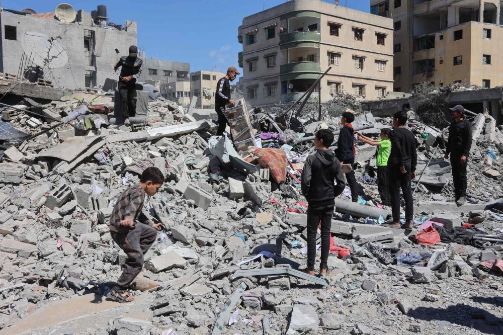 Palestinians inspect the rubble of the Elias Tarazi family house, after it was destroyed in an Israeli strike in al-Sabra neighbourhood in Gaza City on Wednesday. AFP