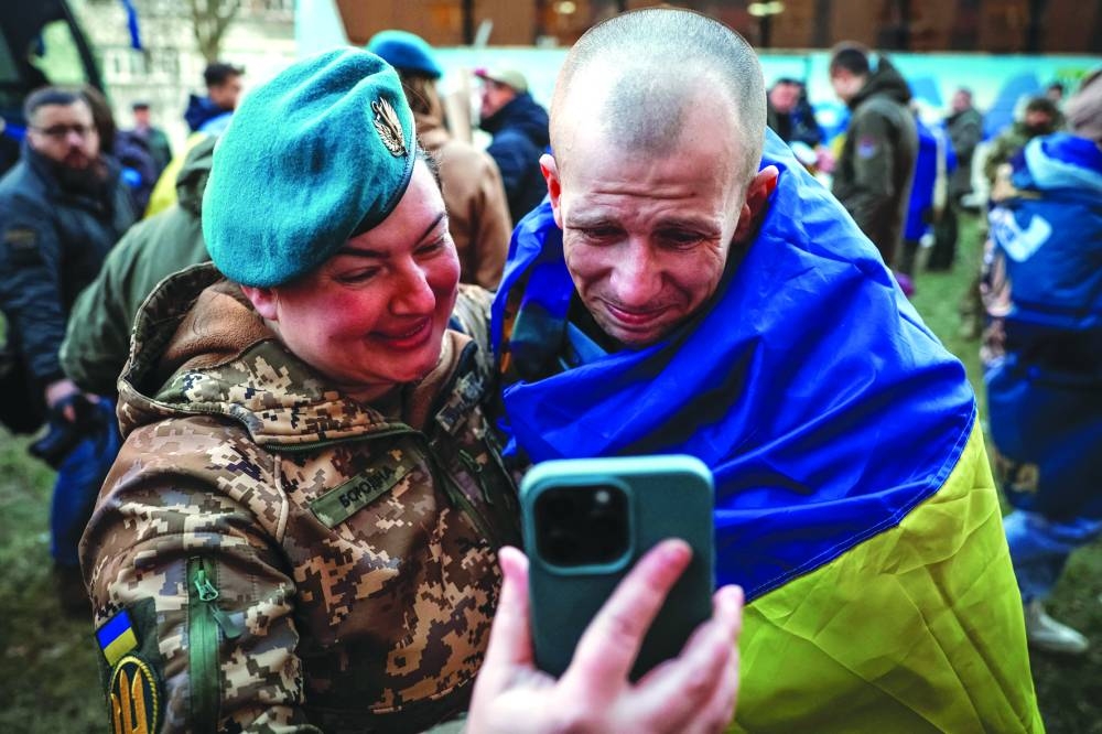 A Ukrainian prisoners of war (POW) talks to his relative during a call as he returns after a swap, in an undisclosed location in Ukraine Wednesday.