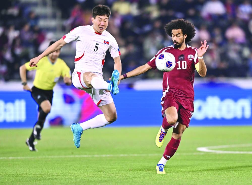 Qatar captain Akram Afif (right) vies for the ball with North Korea’s Jong Hwi-nam during the World Cup qualifying match at the Jassim Bin Hamad Stadium in Doha on Thursday. PICTURE: Noushad Thekkayil