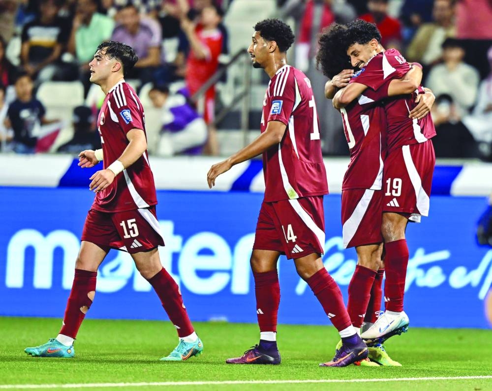 Qatar’s Ahmed al-Ganehi (right) celebrates with teammates after scoring a goal. PICTURE: Noushad Thekkayil