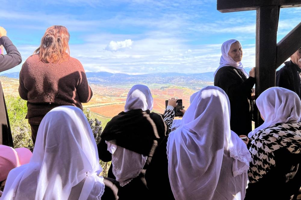 People stand at a lookout point overlooking the Israel-Lebanon border on its Israeli side, on Saturday. REUTERS