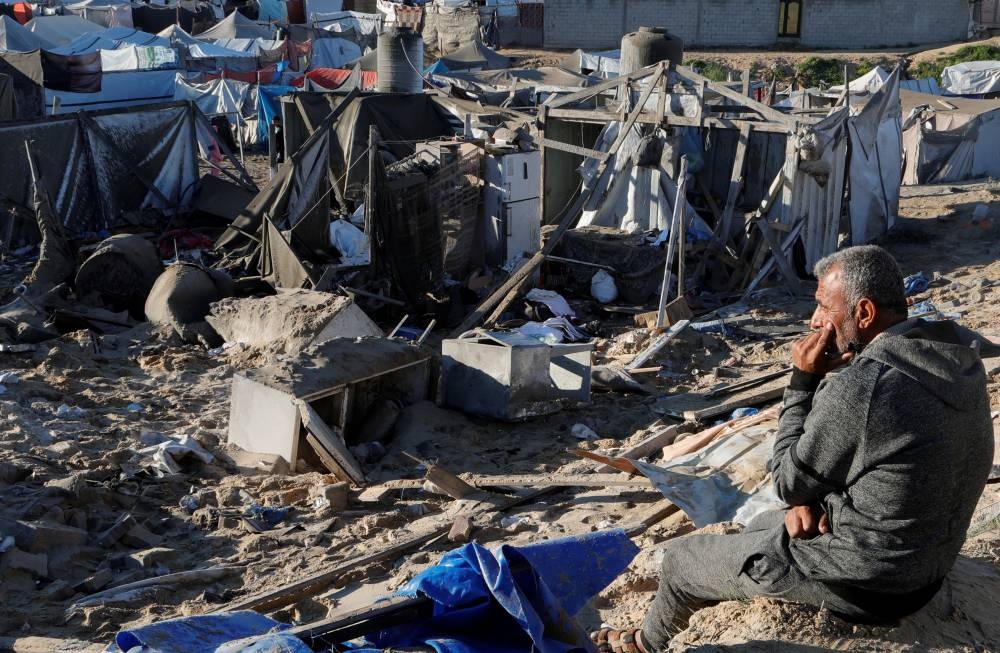 A Palestinian man looks on at the scene where an Israeli strike killed Hamas political leader Salah al-Bardaweel and his wife in their tent shelter, in Khan Younis in the southern Gaza Strip, on Sunday. REUTERS
