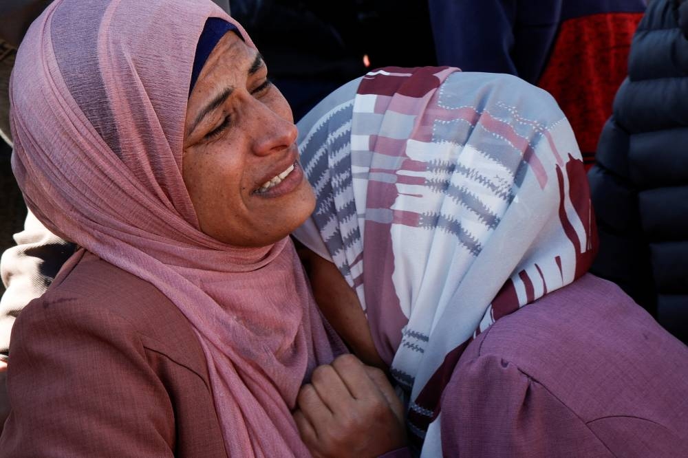 Women mourn Palestinians killed in Israeli strikes, at Nasser hospital in Khan Younis in the southern Gaza Strip, on Sunday. REUTERS
