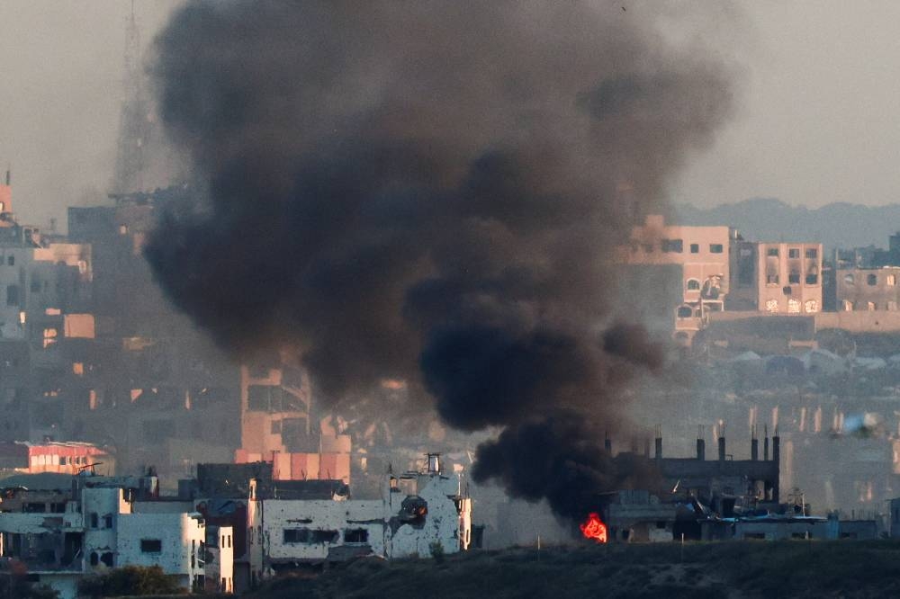 Smoke rises from a burning building in North Gaza, Sunday.