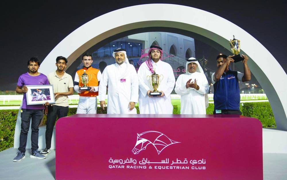 Connections of Mutamarrid celebrate after the grey horse won the Ras Al Noof Cup at the Al Rayyan Racecourse.