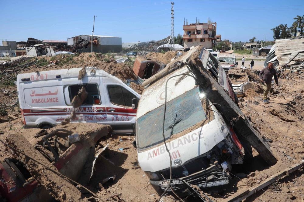 Palestinians inspect the damage at an ambulance repair yard hit in Israeli strikes in the al-Maghazi refugee camp in the central Gaza Strip, on Monday. AFP