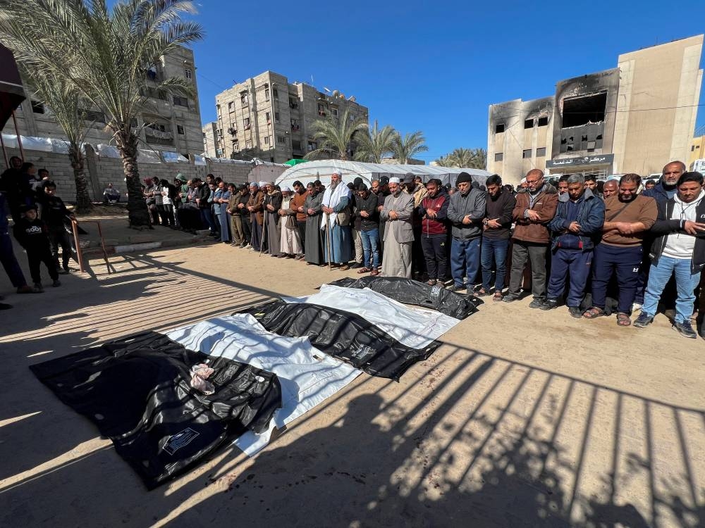 Mourners pray next to the bodies of Palestinians killed in Israeli strikes, at Nasser hospital in Khan Younis, in the southern Gaza Strip, on Monday. REUTERS