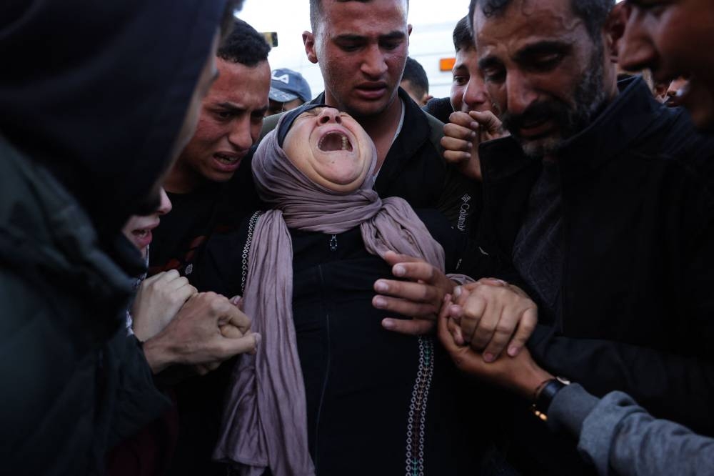Relatives mourn Palestinian journalist Hussam Shabat, who collaborated with Al Jazeera Mubasher, during his funeral at the Indonesian Hospital in Beit Lahia, northern Gaza Strip, on Monday. AFP