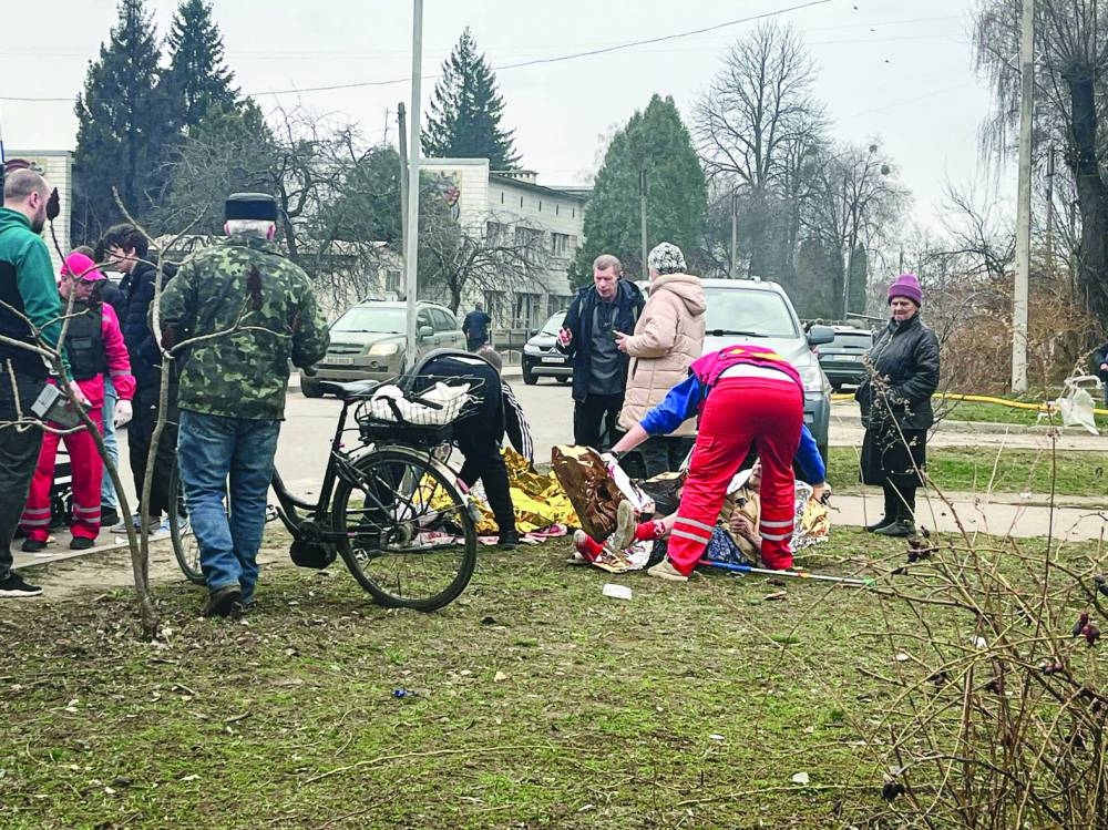 A Ukrainian medic treats an injured person following a missile attack in Sumy, northeastern Ukraine, on Monday.
