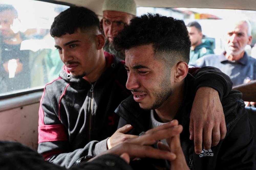 People inside a vehicle react as they mourn for Palestinians killed in Israeli strikes, at Al-Aqsa Martyrs hospital, in Deir Al-Balah in the central Gaza Strip, on Tuesday. REUTERS