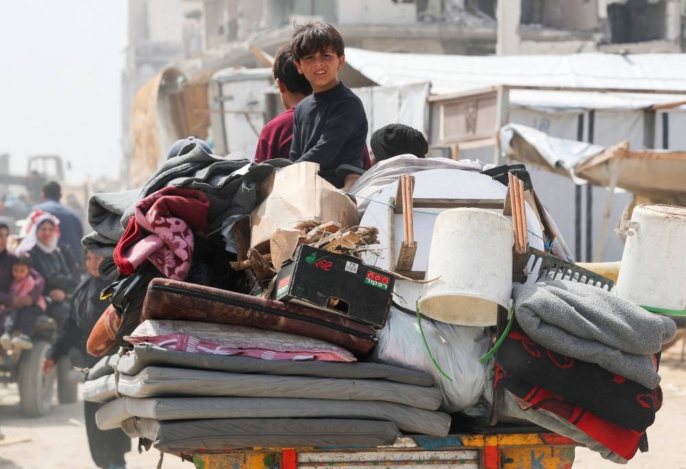 A Palestinian boy looks on as they make their way to flee their homes, after the Israeli army issued evacuation orders, in Jabalia, in the northern Gaza Strip, on Tuesday. REUTERS