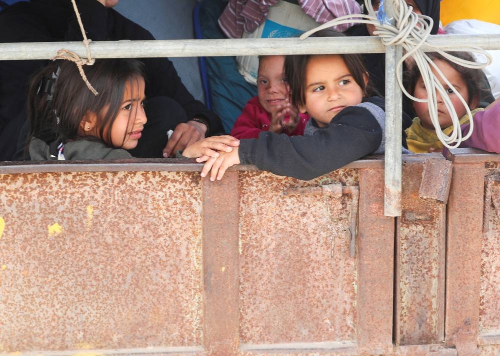 Palestinian girls look on as they make their way to flee their homes, after the Israeli army issued evacuation orders, in Jabalia, in the northern Gaza Strip, on Tuesday. REUTERS