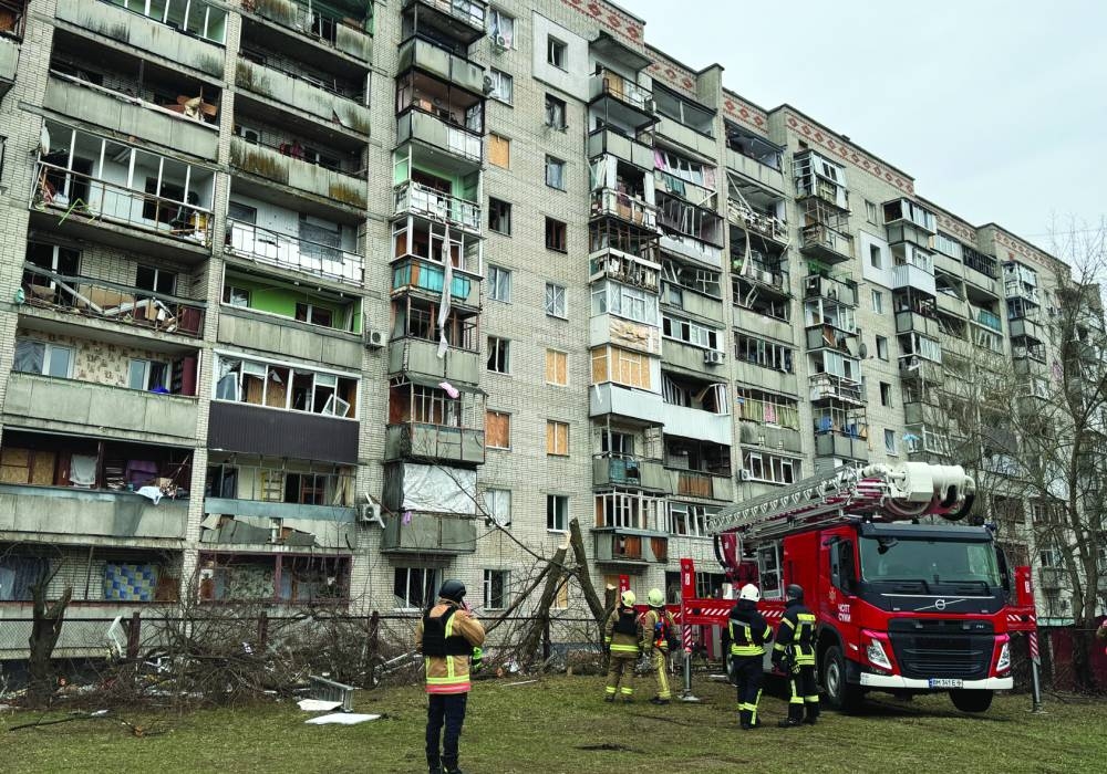 Rescuers work at the site of an apartment building hit by a Russian missile strike in Sumy, Ukraine Tuesday