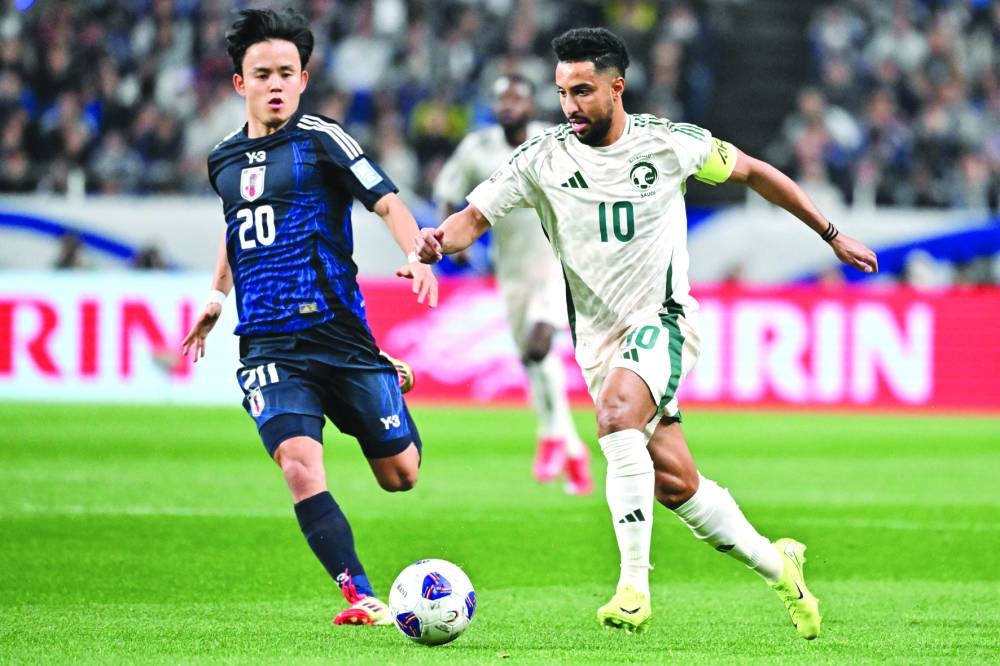 Saudi Arabia’s Salem al-Dawsari (right) fights for the ball with Japan’s Takefusa Kubo during the 2026 World Cup qualification match in Saitama on Tuesday. (AFP)