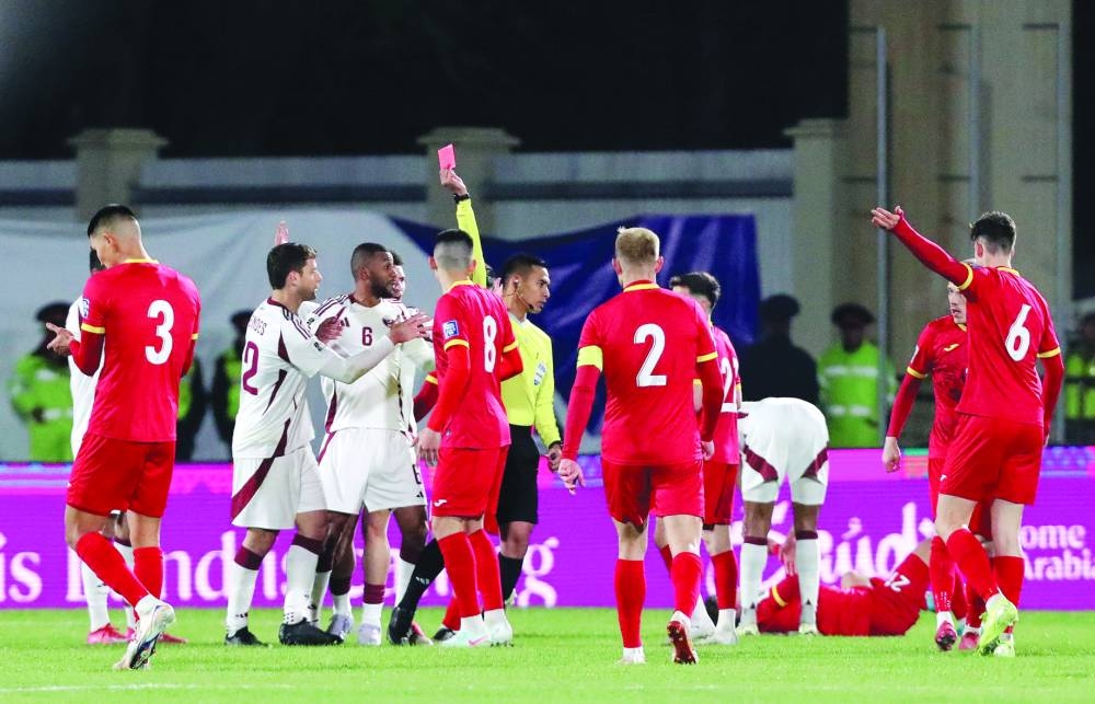 Qatar players react as referee shows red card to Lucas Mendes during their Group A World Cup Asian qualifying match against Kyrgyzstan in Bishkek, Kyrgyzstan, on Tuesday. (Reuters)