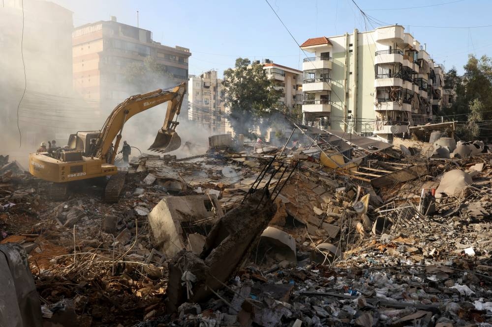 Heavy machinery operates at the site of an Israeli strike, in Beirut southern suburbs, Lebanon, on Friday. REUTERS