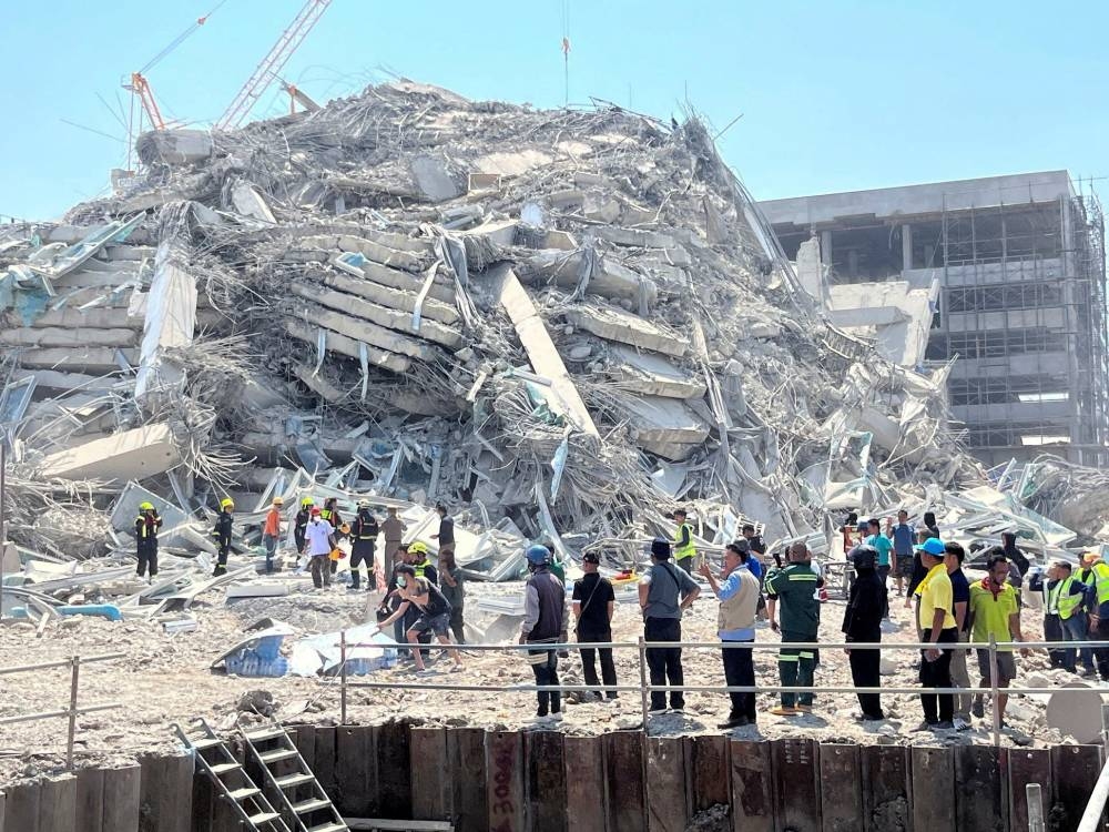 Rescuers work at the site of a collapsed building after the tremors of a strong earthquake that struck central Myanmar on Friday affected Bangkok, Thailand, on Friday. REUTERS