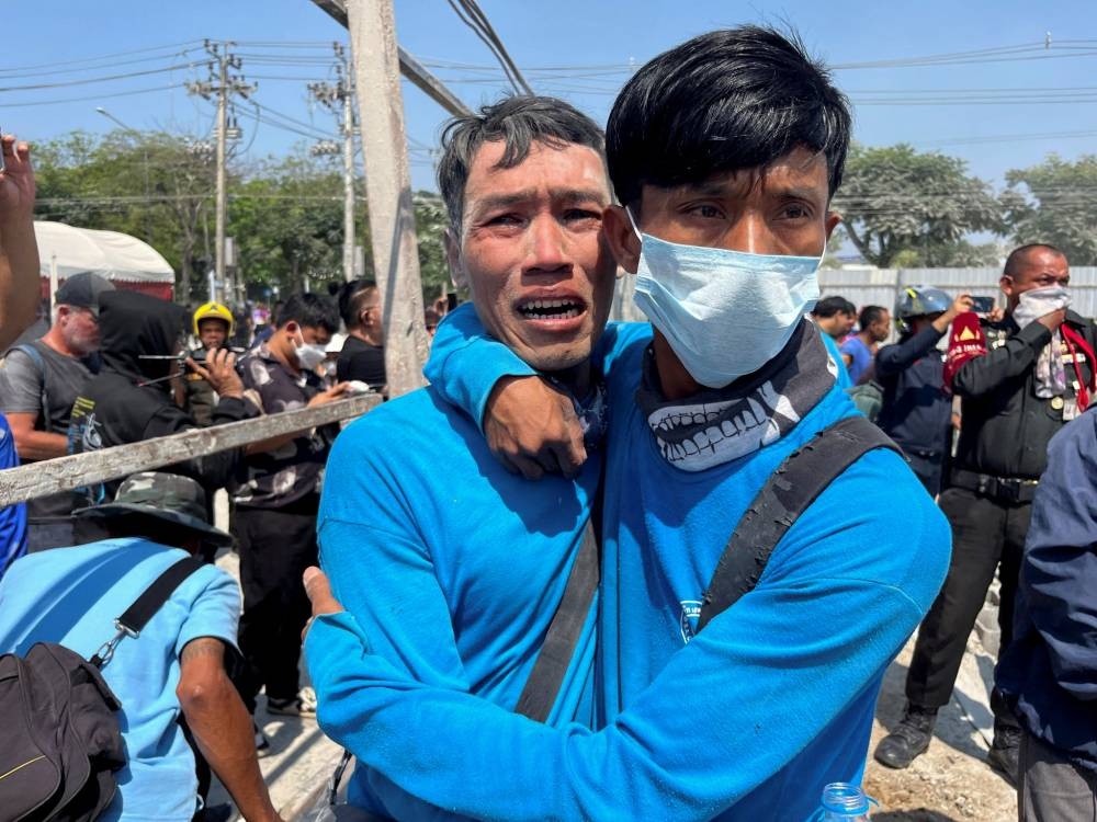 Workers react near a site of a collapsed building after the tremors of a strong earthquake that struck central Myanmar on Friday affected Bangkok, Thailand, on Friday. REUTERS