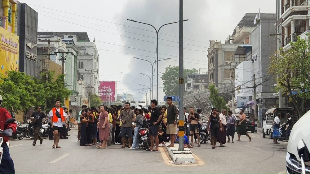 People gather on a street after a strong earthquake struck central Myanmar, in Mandalay, Myanmar, on Friday. REUTERS