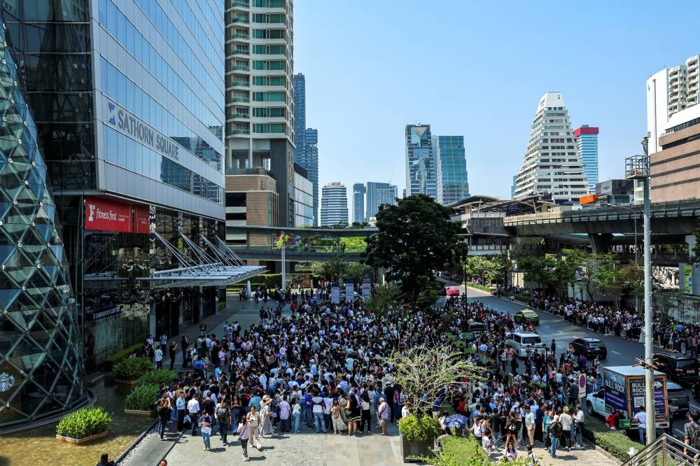 People gather on a street after a strong earthquake struck central Myanmar on Friday, earthquake monitoring services said, which affected Bangkok as well with hundreds of people pouring out of buildings in the Thai capital in panic after the tremors, in Bangkok, Thailand, on Friday. REUTERS