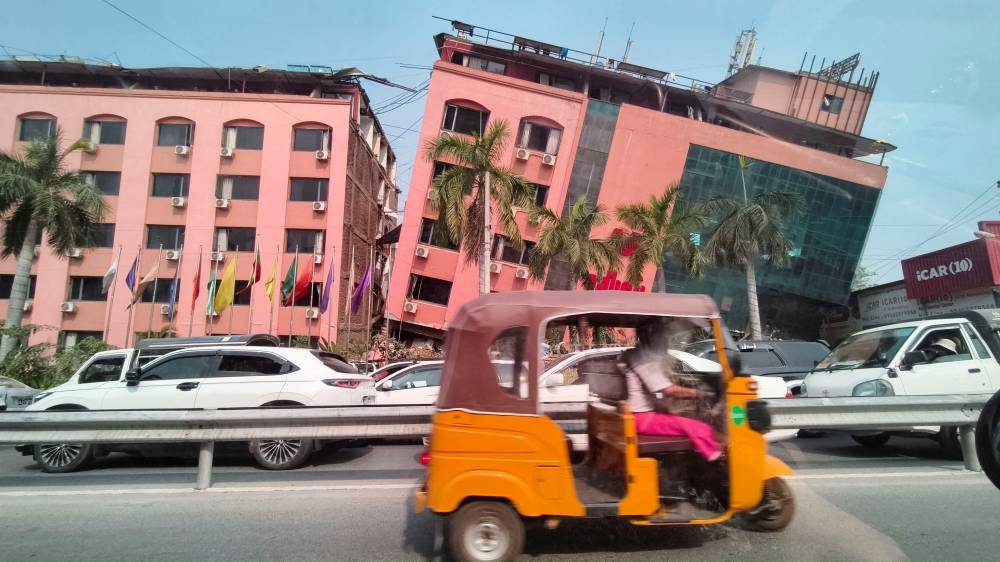 Motorists ride past a damaged building after a strong earthquake struck central Myanmar, in Mandalay, Myanmar, on Friday. REUTERS