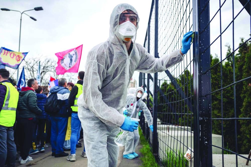 
Student protesters stage a ‘disinfection’ performance during a demonstration outside a pro-government Informer television station in Belgrade. – AFP 