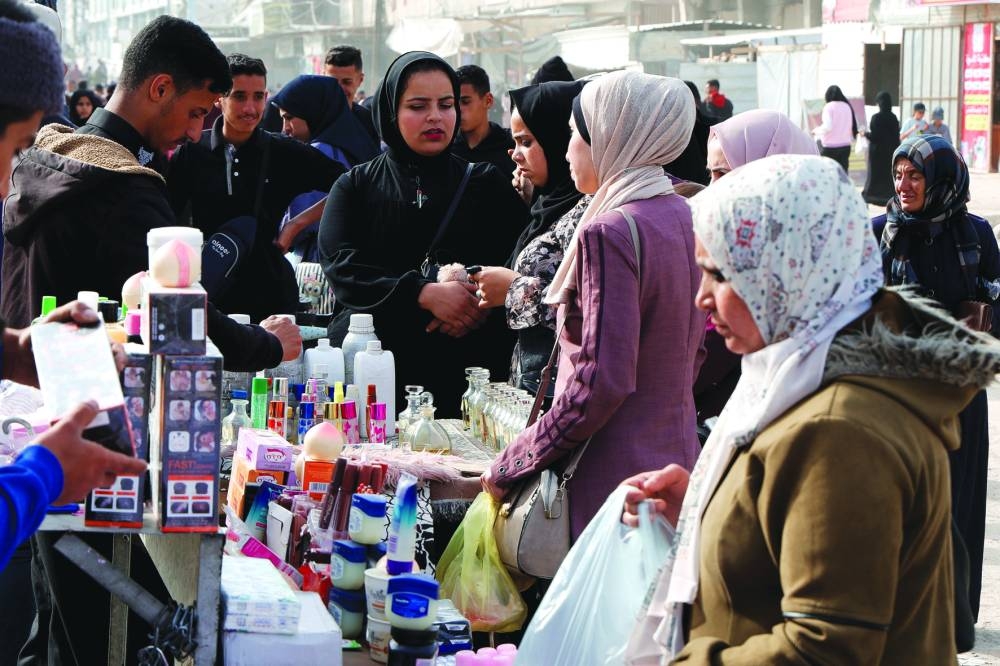 Palestinians shop at a market ahead of the upcoming holiday of Eid al-Fitr,  in Khan Younis in the southern Gaza Strip Saturday.