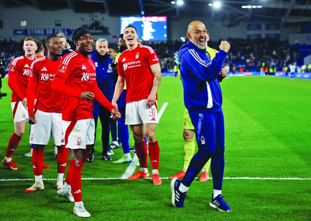 Nottingham Forest manager Nuno Espirito Santo and players celebrate after they defeated Brighton & Hove Albion in the FA Cup quarter-final in Brighton on Saturday. (Reuters)