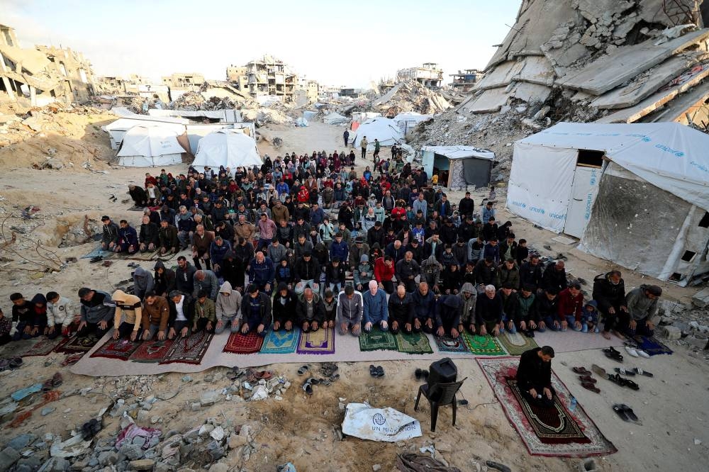 Palestinian Muslims attend Eid al-Fitr prayer marking the end of the holy fasting month of Ramadan, in Jabalia, in the northern Gaza Strip, on Sunday. REUTERS